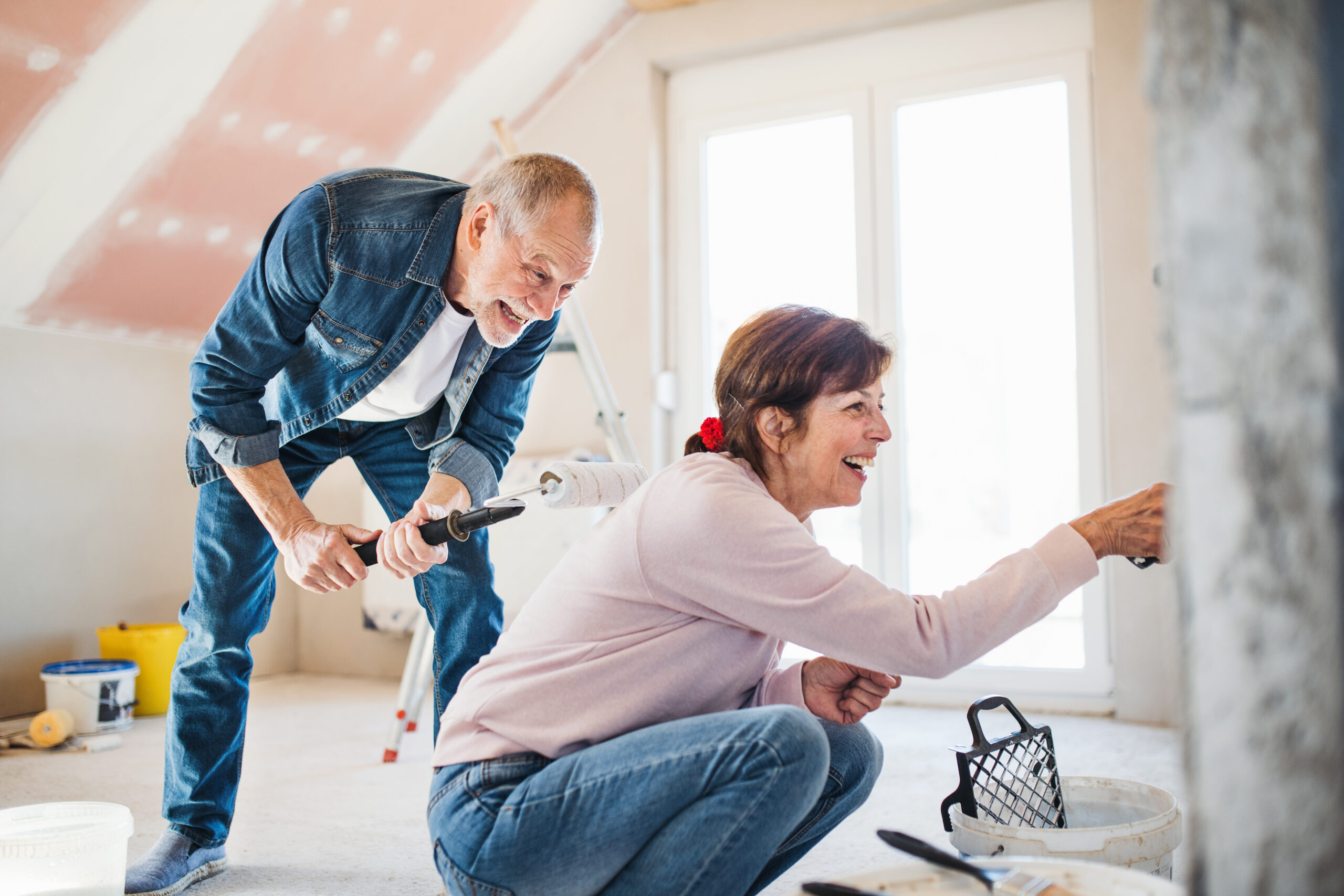 Couple painting a wall